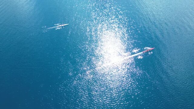 Aerial View of Rowing Race Competition in Turquoise Sea Near Coastal Hills. High quality 4k footage