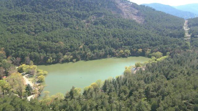 Aerial View of Karagol Lake Surrounded by Dense Green Pine Forest in Izmir Turkey. High quality 4k footage