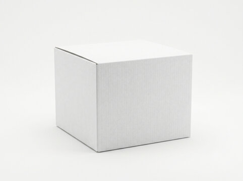 Small white paper cardboard box standing on surface