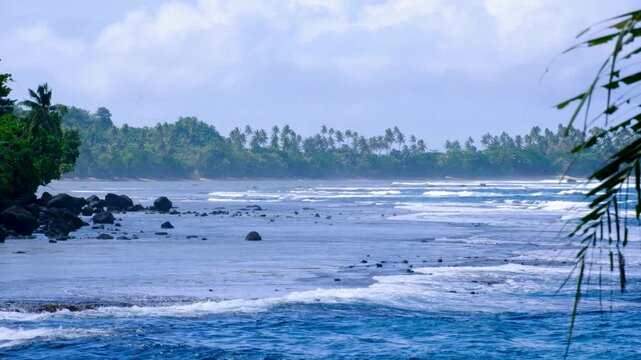 Scenic Fijian ocean view of Lavena Coastal Walk with rolling waves and forest tree lined coastline on Taveuni Island, Fiji, South Pacific