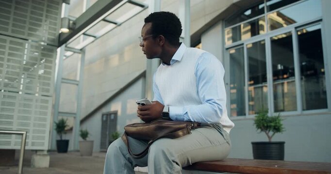 Phone, check watch and black man in city for lift, taxi and wait for transportation. Business person, hailing app and impatient with schedule, commute and booking for travel service in urban town