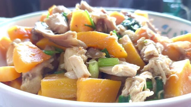 Fried squash butternutwith chicken in plate, indoor Chiangmai Thailand