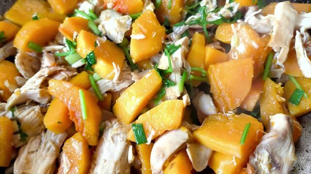  Frying squash butternut with chicken in pan, indoor Chiangmai Thailand.