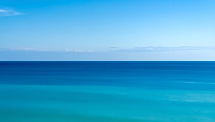 Obraz premium serene ocean horizon with soft blue gradient and minimalist sky at dusk