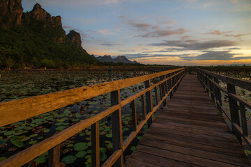 Fototapeta premium Mountains and a wooden pavilion in the evening as the sun is setting, in the background.