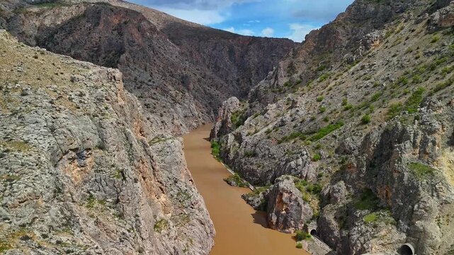 Wide Aerial View of Rocky Canyon with River and Railway Tunnels