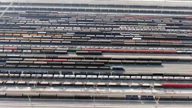 Aerial View of Freight Train Yard with Rail Cars and Tracks