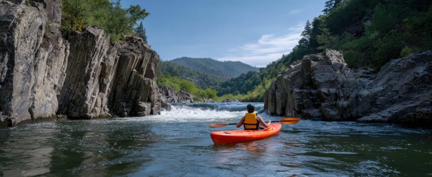 couple gliding in a kayak through a river canyon like love on a winding path