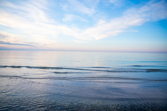 Calm sea horizon on Ruegen island in Germany during evening light over the Baltic Sea. Travel, nature and peaceful coastal atmosphere