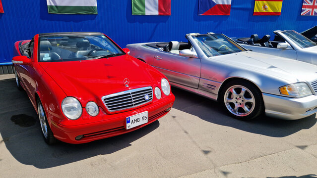Kyiv, Ukraine - May 3, 2026: Red Mercedes-Benz CLK convertible (W208 body) at a car exhibition. Open-top car parked next to other cars. Open-air exhibition of retro and modern cars