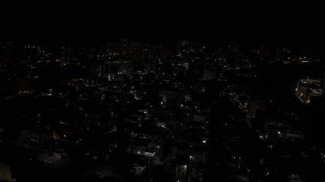 Drone flies east over Polana Cimento B at night in Maputo, Mozambique