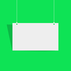 Fototapeta premium Blank white sign hanging on green background