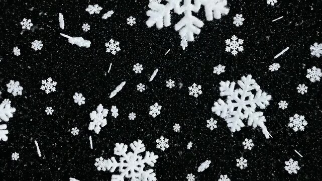 This captivating features a mesmerizing display of white snowflakes drifting lazily against a dark backdrop, evoking a sense of calm and tranquility. The slow-motion footage highlights the intricate