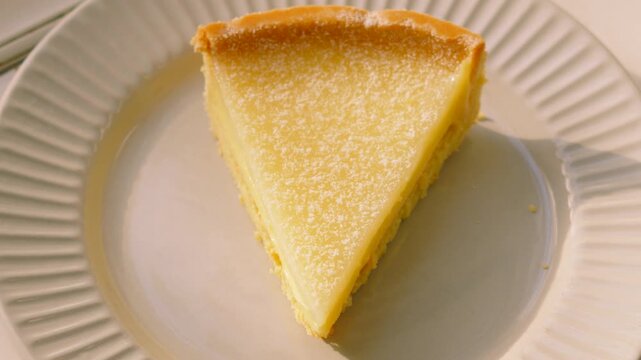 Top Down View of classic French Tarte au Citron on a Plate in Natural Sunlight. Perfect for Food apps, social media montages, high-end restaurant promos. 4K.