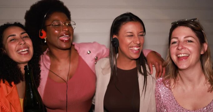 Group of multiracial girls having fun dancing together while listening music with cassette, cd player and vintage boombox stereo outdoor - Party, nightlife and people lifestyle concept 