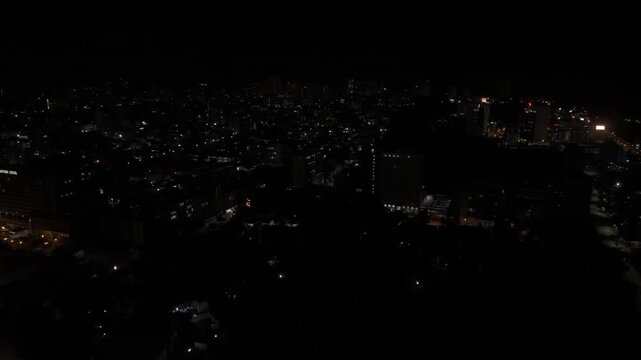 Drone flies east over Central B at night in Maputo, Mozambique