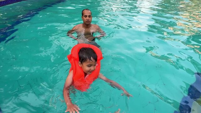 happy family pool activity with young child learning to swim safely
