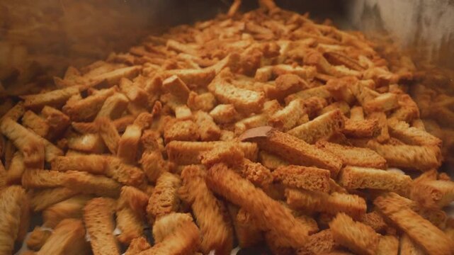 Croutons Tumbling on Factory Conveyor