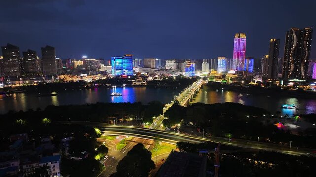 Time-lapse photography of the night view of high-rise buildings and bridges spanning the Yongjiang River in Nanning, Guangxi, China.