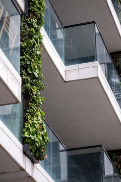 Balcony garden and greenery reshape a modern urban architecture building where plants and sustainable design lift the residential facade