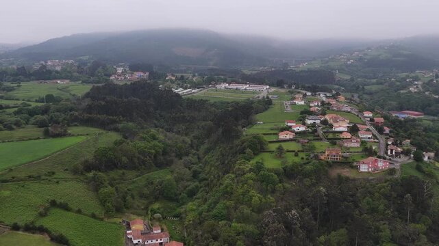 Aerial view of the verdant landscape and traditional houses nestled on the rolling hills of the Asturian countryside Cudillero, Asturias, Spain.
