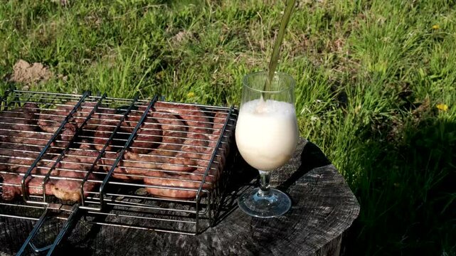 Grilled sausages and steaks Snacks with meat, sausage, French fries, crackling and beer. High quality 4k footage