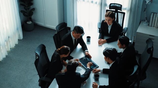 Top view of professional project manager present financial graph while holding tablet. Diverse group working together to analyze stock market investment data graph ay business conference. Directorate.