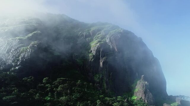 Drone view of Kotebetta cliffs in Western Ghats covered in mist and scenic natural beauty