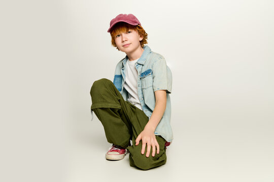 Stylish little boy showcasing vibrant fashion in playful pose