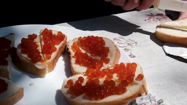 cut a buttered bun into triangles for sandwiches. to spread butter on bread white bread