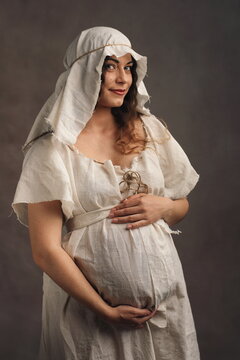 Authentic Maternity Portrait of Smiling Pregnant Woman in Medieval Gown
