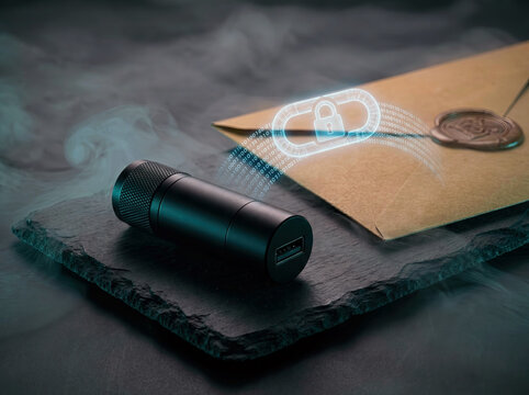 Encrypted sealed envelope beside black usb flashlight on slate with holographic padlock and binary stream, smoky low-light background concept of covert digital security