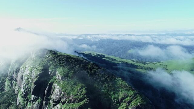 High angle view of mountain range covered in dense fog creating misty scenic landscape