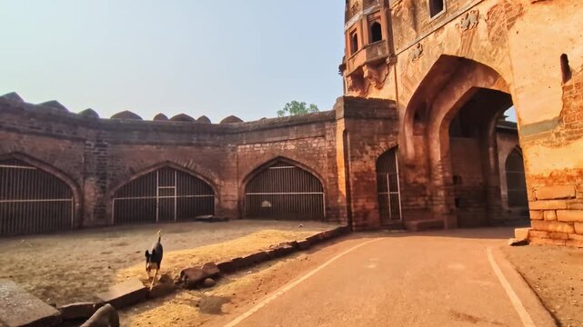 Reveal shot of Sharza Darwaza with fort road and sky at bidar, karnataka, india. day time, pan shot, hand held shot, 4k.