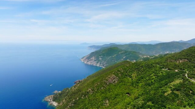 Drone shot along of the steep coastline of Liguria, summer day in Italy