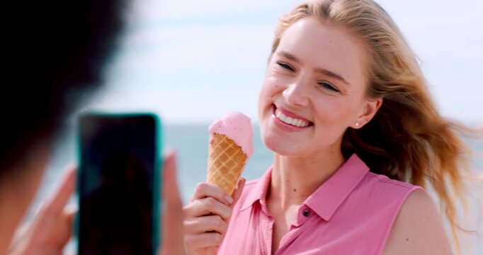 Influencer, phone screen and friends at ocean with ice cream, laugh or digital memory on summer vacation. Happiness, windy or people with cone, social media update or content creation on seaside trip