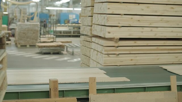 Close-up of an automated production line with timber slats in motion within a modern wood processing facility