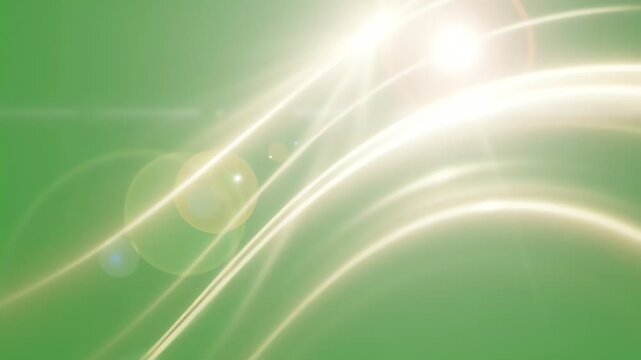 Abstract glowing light streaks on green background.