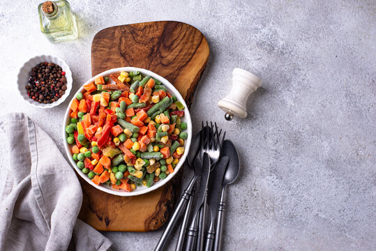 Frozen mix of vegetables on dark background