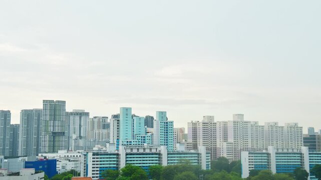 Panoramic zoom out view Skyline of residential high-rise buildings in Singapore. Blue and white HDB flats and modern apartments showcase urban density and planning in the heartlands