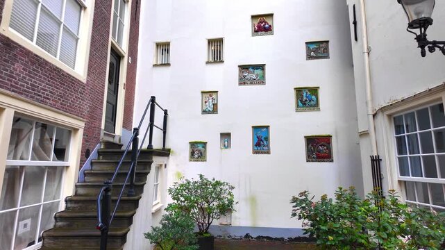 beautiful 17th century facade stones with religous motifs on a wall in Begijnhof, Amsterdam