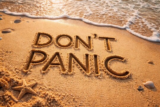 Motivational Dont Panic words carved deep in beach sand