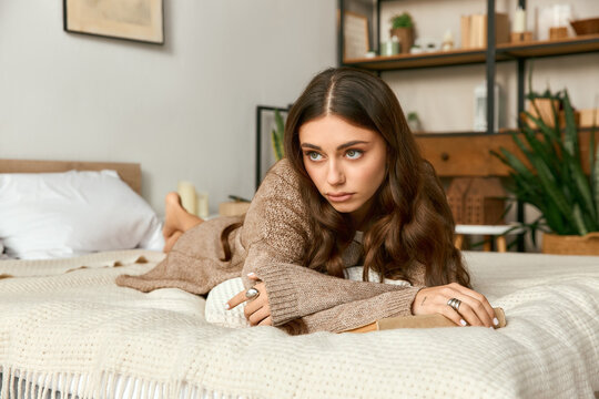 Cozy moments of relaxation in a modern apartment with a beautiful young woman