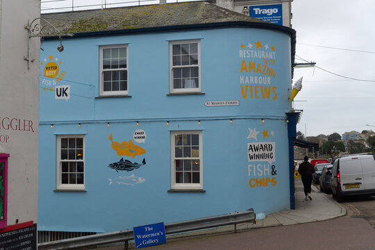 Cityscape at English city of Falmouth with blue facade of fish and chips restaurant on a cloudy winter day. Photo taken February 2nd, 2026, Falmouth, United Kingdom.