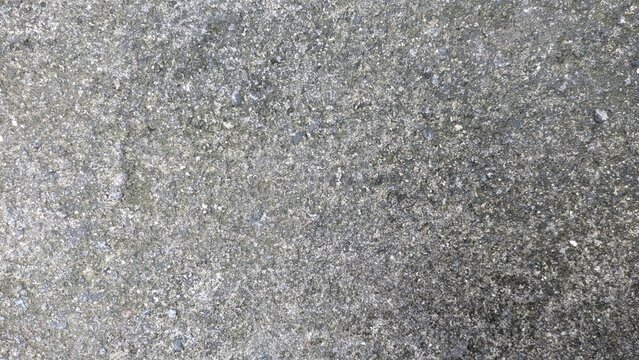 Gray asphalt road texture background, top view of rough grainy stone bitumen surface