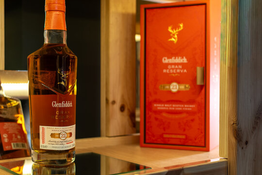 Bottle of Glenfiddich 21 Year Old Gran Reserva single malt scotch whisky with gift box on a wooden shelf in a warm ambient bar setting. Ukraine, Zhytomyr, May 04, 2026