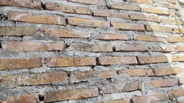 Close-up of Red Brick Wall Texture with Sunlight and Shadows