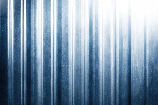 Textured steel surface with blue corrugation and high key lighting background copy space