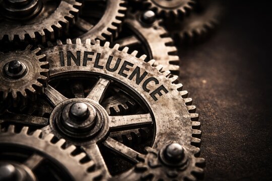 Macro view of interlocking gears featuring influence wording and copy space design