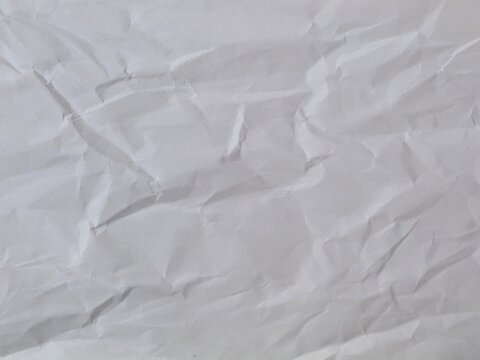 Crumpled white paper texture background with wrinkled surface, perfect for vintage designs, recycled themes, or creative overlays in graphic design projects